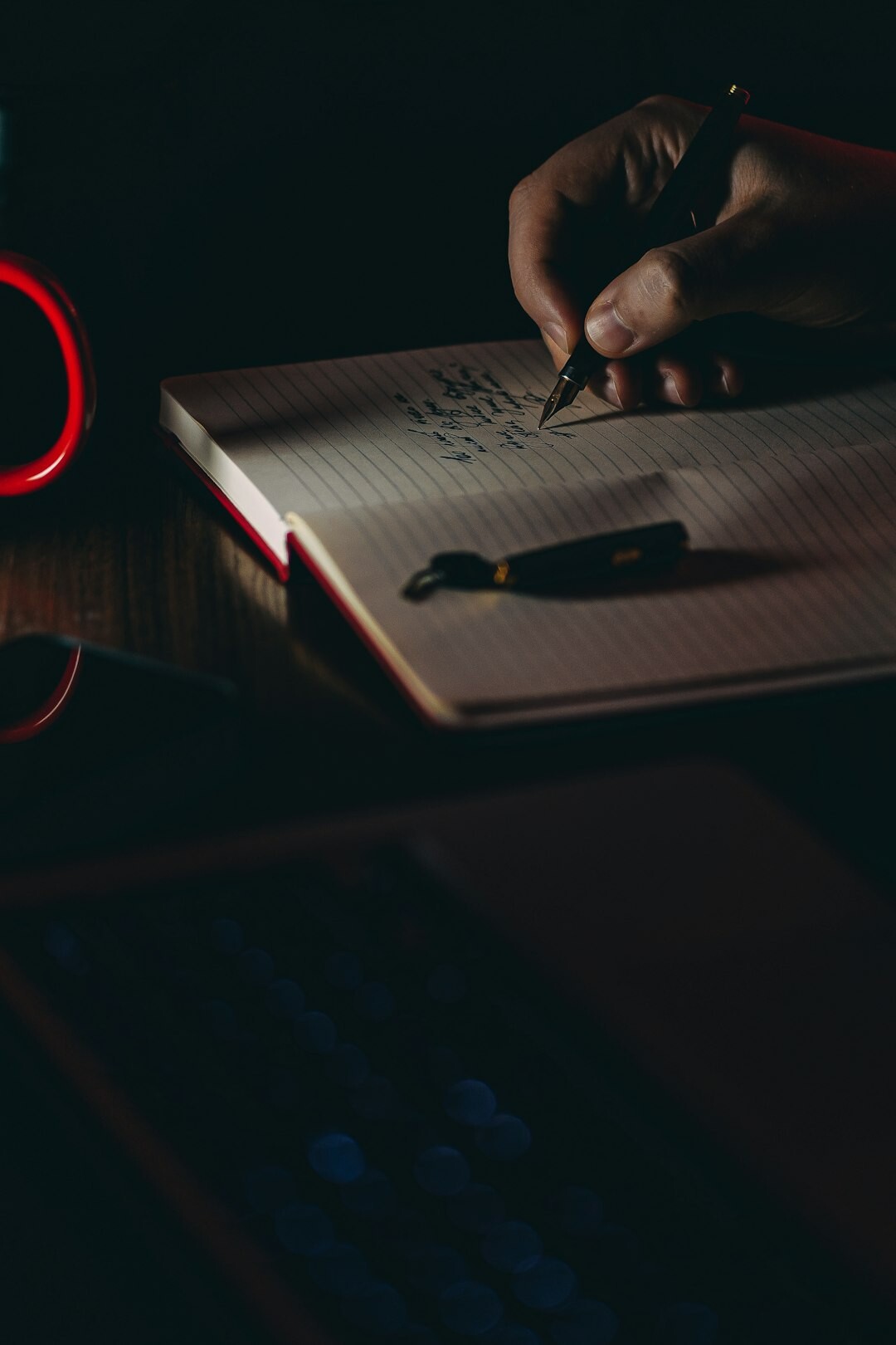 person writing in notebook