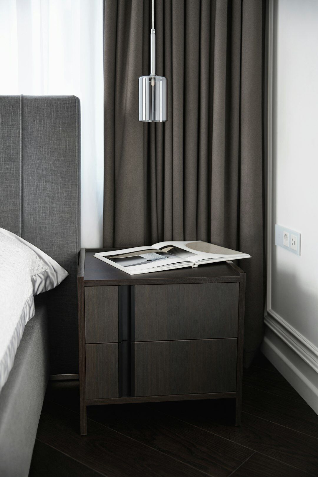 book open on bedside table
