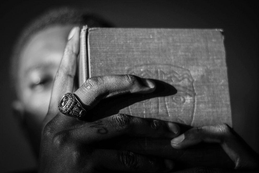 person holding old mystery book