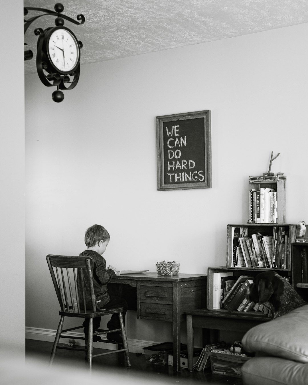 Croatian writer sitting at a wooden desk with a typewriter and warm lamp light